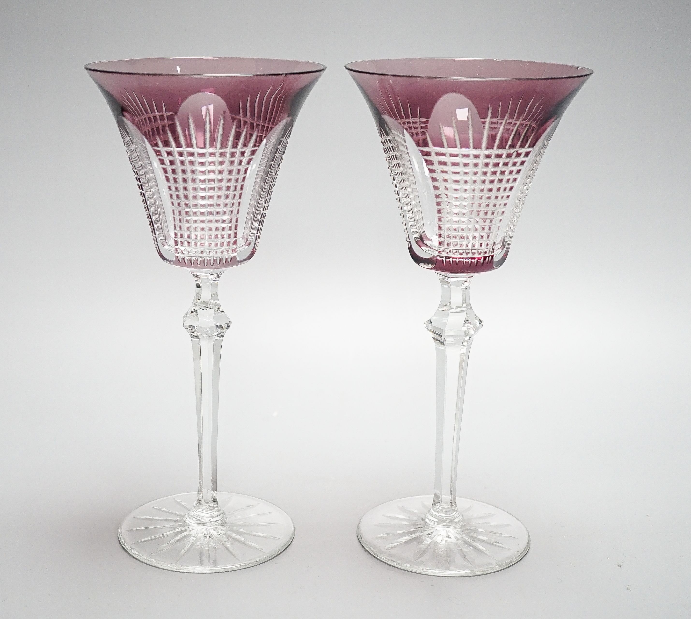 A set of fourteen cut amethyst flashed wine glasses, 21cm
